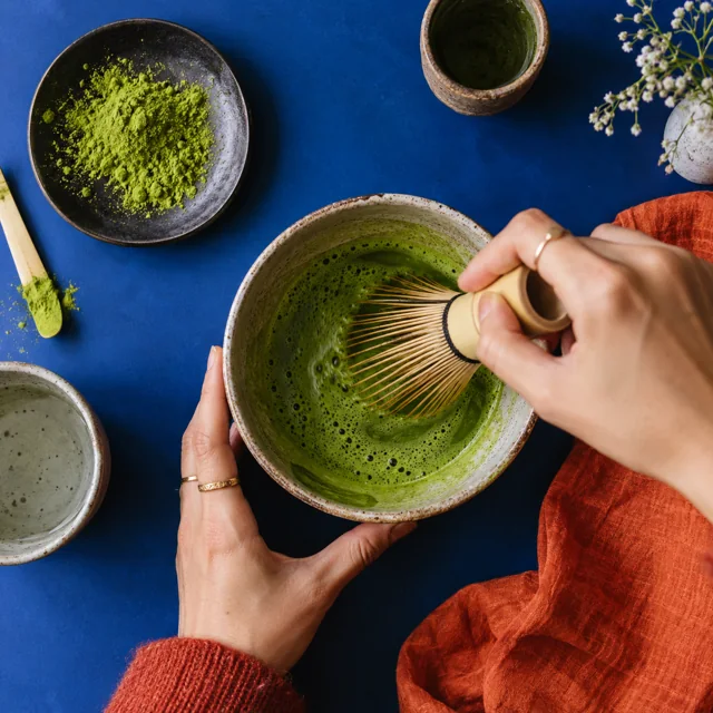 Illustrative close-up of a creator preparing matcha.